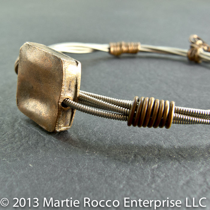 guitar string bangle bracelet with copper focal bead and wire wrap 24