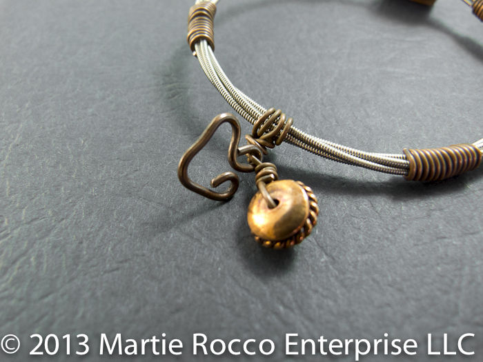 Guitar String bangle bracelet with copper focal bead and wire wrap