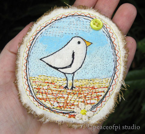 Bird,Brooch,Mixed,Media,Stitch,brooch, bird, fabric, mixed media, stitch, badge, oval, fiber art, jewelery, jewellery, wearable art, button, daisy, painted, off-white, beige, natural, yellow, blue, orange, black, sepia, handmade, stitched, sewing, sewn, canada, peaceofpi