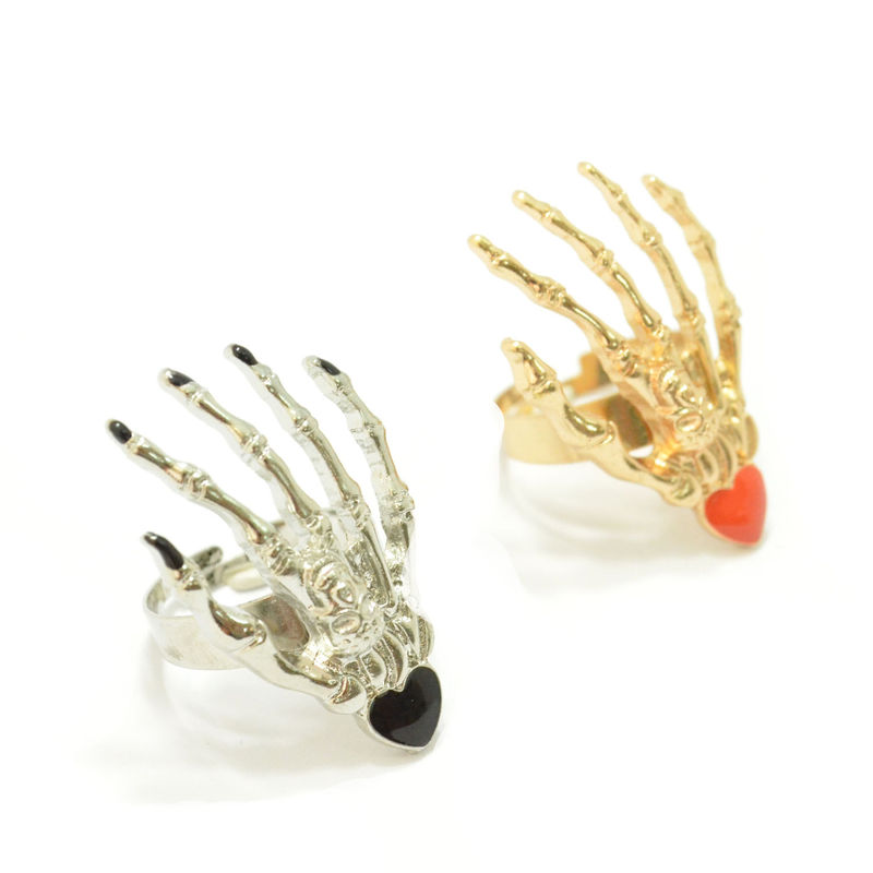 SKELETON HAND WITH SHINY HEART RING - product image  