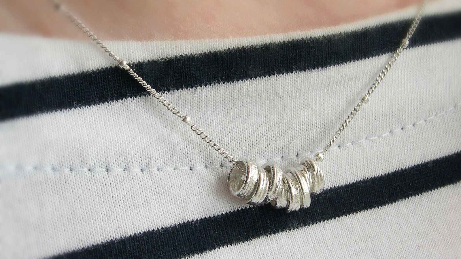 Handmade sterling silver reels necklace by Hazey Designs