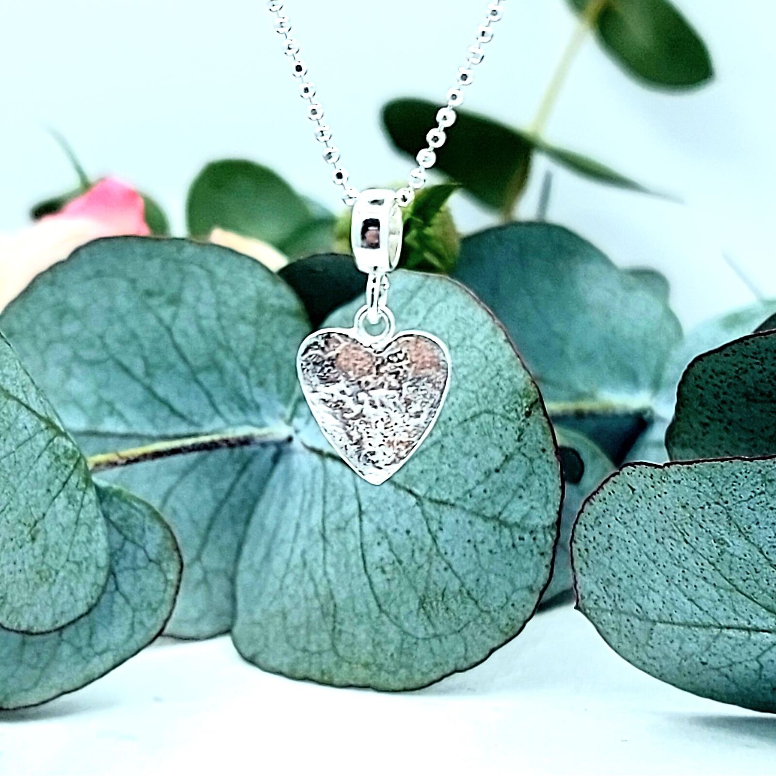 A very cute retuculated heart charm necklace perfect for layering.