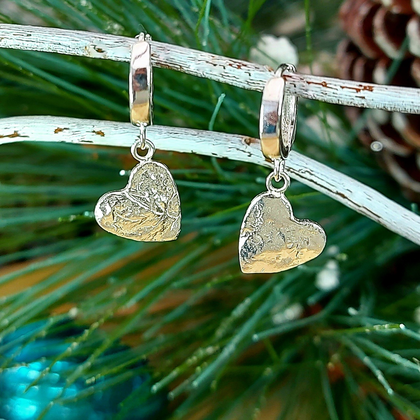 Handmade silver organically textured heart drop huggie earrings by Silver Sparrow Jewellery